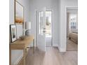 Inviting entryway with light wood floors, neutral paint, and a view of the bedroom and front door at 5011 Neverland Ct, Myrtle Beach, SC 29588