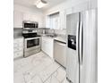 Modern kitchen with stainless steel appliances, granite countertops, and marble floors at 515 37Th Ave. N # 101, Myrtle Beach, SC 29572