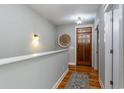 Entry hallway with hardwood floors, decorative wall accents, and a wooden front door with glass inserts at 53 Hope Ln., Pawleys Island, SC 29585