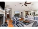 Spacious living room with hardwood floors, a fireplace, and an open floor plan to the kitchen at 53 Hope Ln., Pawleys Island, SC 29585