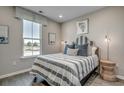 Cozy bedroom with a striped bedspread, complementing pillows, and a window with natural light at 5504 Shelly Lynn Dr., Myrtle Beach, SC 29579