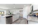Bright kitchen features stainless steel appliances, granite countertops and an undermounted sink on the kitchen island at 572 Strawberry Field Way, Galivants Ferry, SC 29544