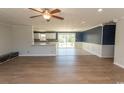 Open-concept living room with hardwood floors, a ceiling fan, and sliding doors to the backyard at 7638 Highway 905, Longs, SC 29568