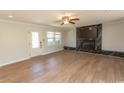 Bright living area with hardwood floors, fireplace, TV, and neutral paint at 7638 Highway 905, Longs, SC 29568