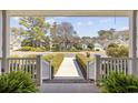 Inviting view from the front porch, showcasing the neighborhood street and manicured hedges at 820 Morrall Dr., North Myrtle Beach, SC 29582
