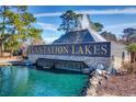 The Plantation Lakes entrance features a layered pyramid water fountain flowing into an aquamarine lake at 8504 Juxa Dr., Myrtle Beach, SC 29579
