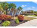 Inviting home featuring mature landscaping, palm trees, and a well-manicured lawn at 8504 Juxa Dr., Myrtle Beach, SC 29579
