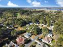 A tranquil aerial view showing the property surrounded by mature trees and stunning water views at 86 Old Barge Dr., Pawleys Island, SC 29585