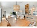 Elegant dining room with hardwood floors, decorative lighting, and a view into the adjoining kitchen and living area at 9648 Bradford Ln., Murrells Inlet, SC 29576