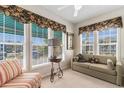 Bright sun room with large windows, custom curtains, and comfortable seating creates a relaxing atmosphere at 9764 Leyland Dr. # 9764 - 5, Myrtle Beach, SC 29572