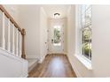 Welcoming foyer with hardwood floors, a white door with glass, and staircase at 1219 Inlet View Dr., North Myrtle Beach, SC 29582