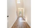 Inviting foyer with tall ceilings, wood-look flooring, and natural light streaming through the front door at 1219 Inlet View Dr., North Myrtle Beach, SC 29582