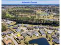 Community aerial view with a golf course, water features, and well-maintained landscaping at 324 Highfield Loop, Myrtle Beach, SC 29579