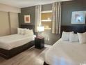 Cozy bedroom featuring two beds with fresh linens and tasteful wall decor at 3500 N Ocean Blvd. # 1203, North Myrtle Beach, SC 29582