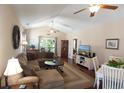Comfortable living room showcasing a plush sectional, ceiling fans, hardwood floors, and abundant natural light at 408 7Th Ave. S, North Myrtle Beach, SC 29582