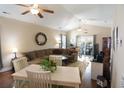 Spacious living room featuring a cozy sectional, ceiling fans, and a sliding glass door to the outside at 408 7Th Ave. S, North Myrtle Beach, SC 29582