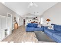 Bright living room featuring vaulted ceiling, modern furnishings, and an open floor plan flowing into the kitchen at 4827 Orchid Way # 301, Myrtle Beach, SC 29577