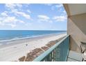 Scenic balcony view of the beach and ocean, highlighting the beachfront living experience at 501 S Ocean Blvd. # 1002, North Myrtle Beach, SC 29582