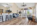 Bright, open living area with wood floors, vaulted ceiling, and access to a screened porch at 5022 Belleglen Ct. # 202, Myrtle Beach, SC 29579