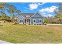 Charming blue home with manicured lawn and inviting front entrance at 529 Oak Lawn Rd., Georgetown, SC 29440