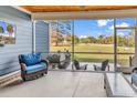 Relaxing screened porch with comfortable seating and outdoor grill area at 529 Oak Lawn Rd., Georgetown, SC 29440