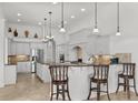 Modern kitchen featuring white cabinetry, granite countertops, stainless steel appliances, and a breakfast bar at 7268 Seville Dr., Myrtle Beach, SC 29572