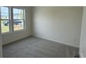 Cozy bedroom featuring carpet flooring and a large window providing natural light at 1025 Jase Dr., Longs, SC 29568