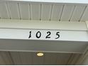 Close up of the house number '1025' on a white exterior wall at 1025 Jase Dr., Longs, SC 29568