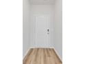 Clean entryway features a white door and wood-look flooring that adds warmth to the space at 147 Joyce Dr, Longs, SC 29568