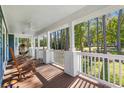 Inviting front porch with rocking chairs, white railings, and scenic views of the lush neighborhood at 160 Shipmaster Ave., Pawleys Island, SC 29585
