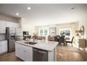 Bright, open kitchen featuring a large island, stainless steel appliances, and a seamless flow to the dining and living areas at 247 Warner Crossing Way, Loris, SC 29569