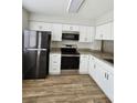 Well-equipped kitchen with stainless steel appliances, granite countertops, and white cabinets provides a modern and functional space at 703 S 1St Ave. S # 34D, North Myrtle Beach, SC 29582