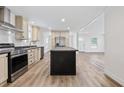 Well-lit kitchen boasts an island, stainless appliances, and modern finishes at 1236 Heritage Rd., Loris, SC 29569