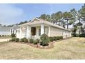 Well-maintained home featuring manicured landscaping, a charming front porch, and neutral exterior paint at 1652 Murrell Pl., Murrells Inlet, SC 29576