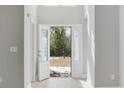 Bright entryway with white trim, a glass-paneled door, and light hardwood flooring at 1892 Blue Bird Rd., Loris, SC 29569