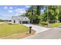 Charming, two-story home with white siding, a two-car garage, and a green lawn at 1892 Blue Bird Rd., Loris, SC 29569