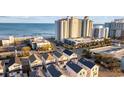 Aerial view of beach homes near a large hotel and ocean at 201-E Madison Ct., Myrtle Beach, SC 29577