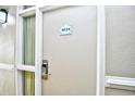 Unit 4034 door with white trim and hardware, alongside an outdoor light at 210 75Th Ave. N # 4034, Myrtle Beach, SC 29572