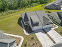 An aerial view of the home showcases its landscaped surroundings, driveway, and neighborhood at 216 Kinross Ct., Little River, SC 29566