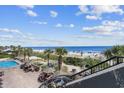 Inviting beach view with a pool, lounge area, stairs, and stunning ocean vista at 2401 S Ocean Blvd. # 259, Myrtle Beach, SC 29577