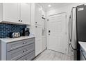 Kitchen boasts white cabinets, a stainless steel refrigerator, and modern appliances at 2710 S Ocean Blvd. # 407-A, Myrtle Beach, SC 29577
