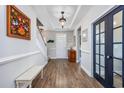 Bright entryway features wood floors, elegant wainscoting, and access to the upper level and main living areas at 318 Board Landing Circle, Conway, SC 29526