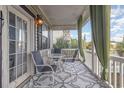 Relaxing porch seating with outdoor table and chairs and neutral outdoor carpet at 3704 Chapel Ln., Myrtle Beach, SC 29588