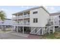 Desirable elevated home with multi-level balconies, beautiful paint, and professional landscaping at 412 Seaside Dr. S, Surfside Beach, SC 29575