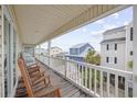 Relaxing porch with wooden rocking chairs and views of neighborhood homes at 412 Seaside Dr. S, Surfside Beach, SC 29575