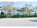 Charming two-story townhomes featuring private balconies and lush landscaping creating a serene and inviting curb appeal at 4850 Cantor Ct. # 202, North Myrtle Beach, SC 29582