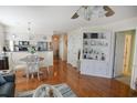 Bright dining area with white table set and hardwood floors flowing into the kitchen and living space at 5030 Windsor Green Way # 203, Myrtle Beach, SC 29579