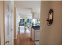 Inviting condo hallway leading to an open living area with hardwood floors and a view of the outdoor space at 5030 Windsor Green Way # 203, Myrtle Beach, SC 29579
