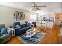 Cozy living room features modern decor, hardwood floors, and an open layout connecting to the kitchen at 5030 Windsor Green Way # 203, Myrtle Beach, SC 29579