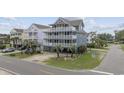 Three story beach house on stilts features multiple decks and covered parking at 510 S Ocean Blvd., Surfside Beach, SC 29575